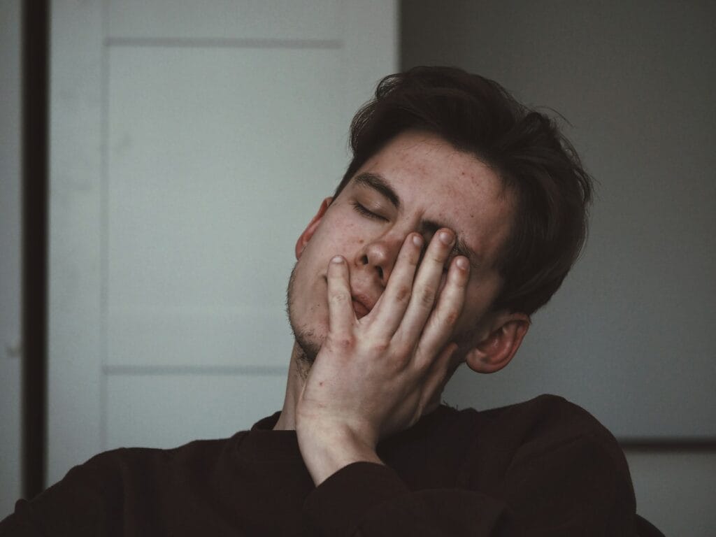 Man holding his cheek from sudden tooth pain — emergency dentist in Jal el Dib, Beirut